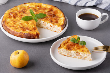 Delicious homemade apple pie served with coffee and garnished with mint leaves on a cozy kitchen table