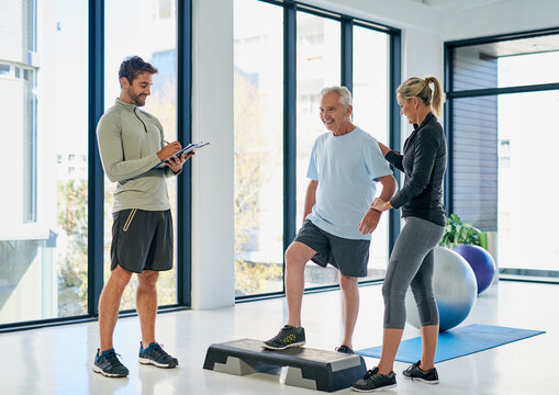 Exercise, clipboard and physiotherapist with senior patient for service, consulting or wellness. Chiropractor, healthcare and man and mature dad and woman for physical therapy, rehabilitation or help