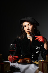 A young woman in stunning attire savors a delicious dish with wine at an upscale event.