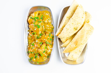 A plate of food with a side of bread