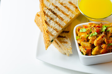 A bowl of pasta with a glass of orange juice