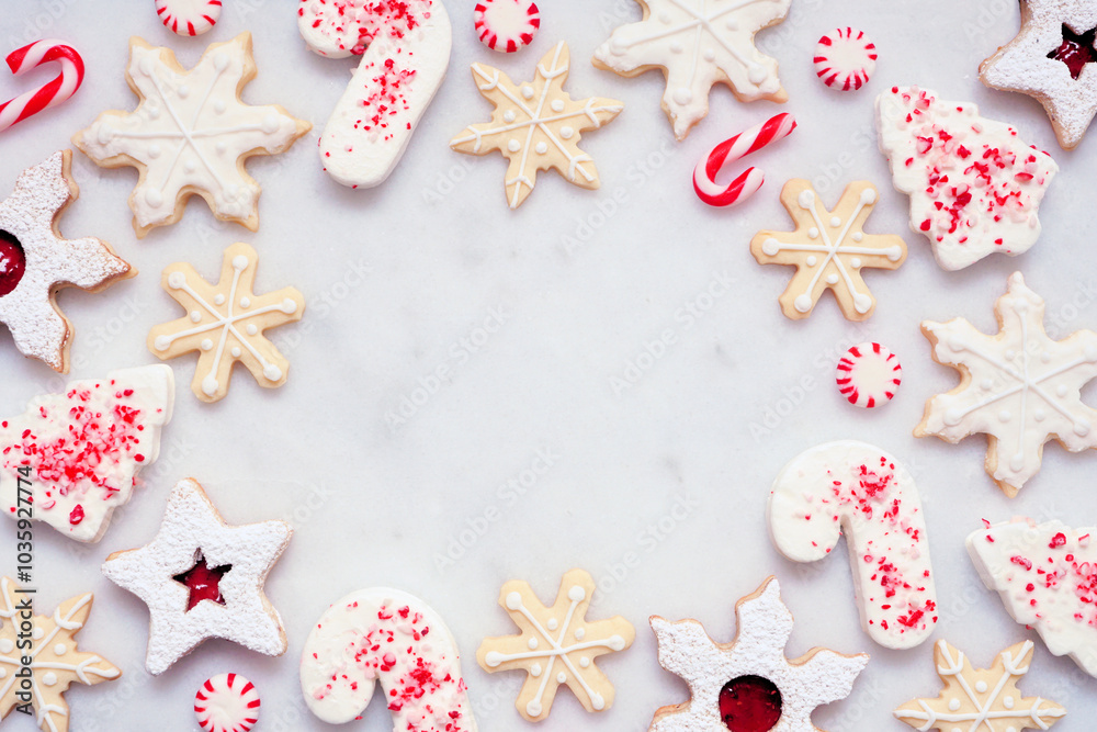 Poster christmas baking frame with an assortment of red and white theme cookies and candies. top down view 