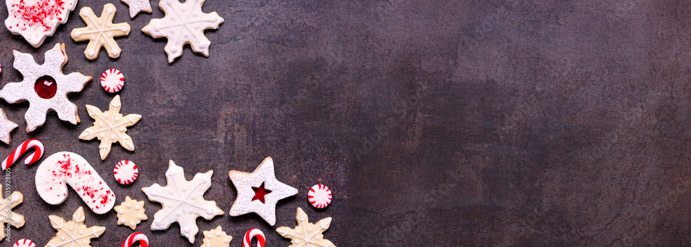 Poster christmas baking corner border with assorted red and white theme cookies and candies. top view on a 