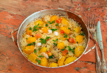 Traditional Brazilian dish rice, chicken and pequi (caryocar brasileinse) known as galinhada goiana