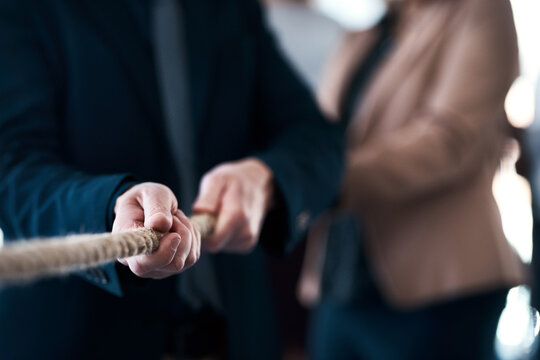 Effort, hands and rope with business people in office together for challenge or competition. Collaboration, mission and team building with employee group in workplace for fight or tug of war game