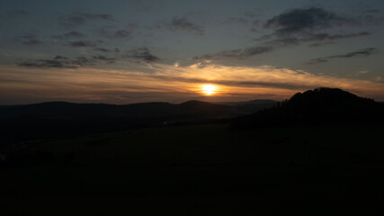 sunset over the mountains. Czech republic, Ceska kamenice.