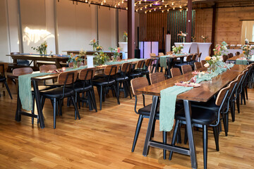 Decorated reception event tables with seafoam green table runners. 