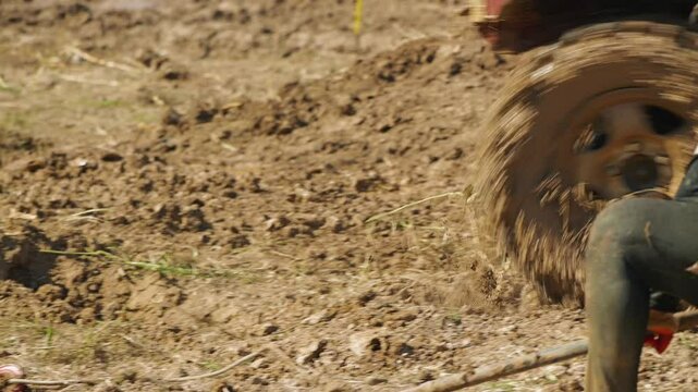 Close-up of an SUV wheel in the mud. Near the anchor for the winch with a cable. The SUV is driving on the mud. Off-road racing