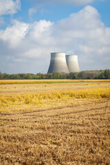 View of the coolin towers of the Trino 2 nuclear power plant (Trino Vercellese, Piedmont, Northern Italy), with ready to harvest paddy fields in the foreground. This power plant was put out of service