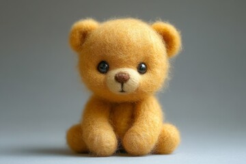 Adorable handmade bear sitting on light background