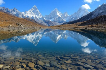 Snow capped mountain reflecting in serene lake on sunny autumn day