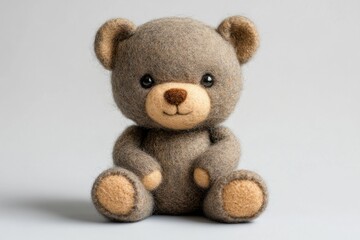Obraz premium Small handmade bear sitting on light background