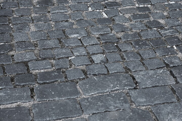 The surface of an old stone pavement.
