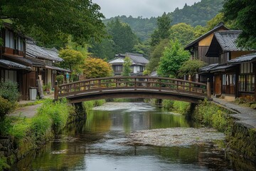 Fototapeta premium Wooden bridge crossing canal with autumn foliage in charming european village