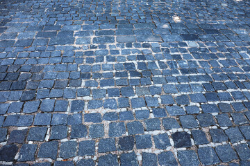 The surface of an old stone pavement.