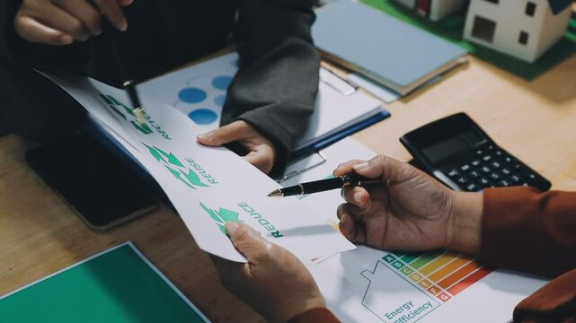 business team people planning and discussing on recycle reduce reuse policy symbol in office meeting room. Green business company and Solar Energy Environment city Concept.