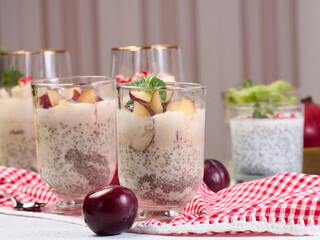 A glass of chia seeds and yogurt, with pieces of plum