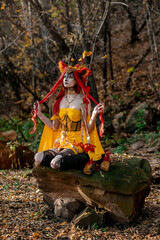 Deer girl in the autumn forest