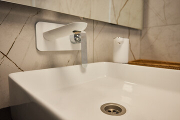 A modern bathroom sink with a sleek faucet and soap dispenser, enhancing the spaces aesthetic