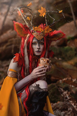 Deer girl in the autumn forest