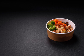 Colorful vegan vegetarian dish consists of tofu, broccoli, quinoa, mushrooms