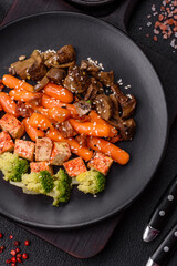 Colorful vegan vegetarian dish consists of tofu, broccoli, quinoa, mushrooms