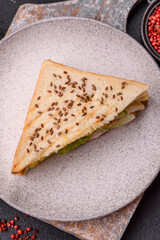 Sandwich with toast bread, meat, tomatoes, cheese, sauce, salt and spices