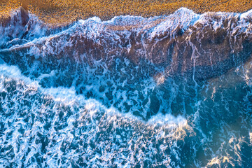 Waves Gently Rolling Onto a Sandy Beach at Sunset, Capturing the Peaceful Essence of Coastal Serenity