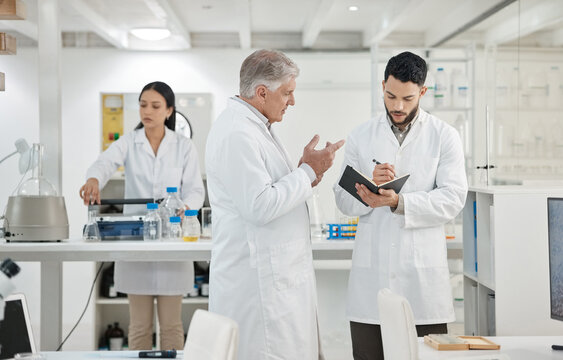 Scientist, men and writing in notebook in lab for disease experiment, medical study and dna process. Researcher, people and molecule research with information, vaccine results and healthcare solution