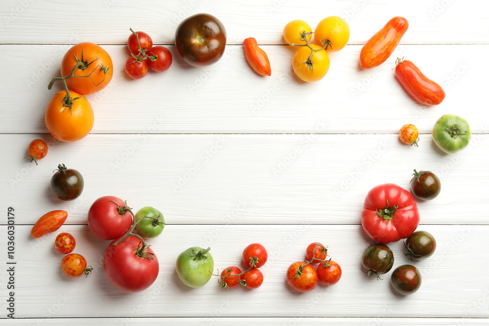 Canvas Prints Frame made of different ripe and unripe tomatoes on white wooden table, flat lay. Space for text