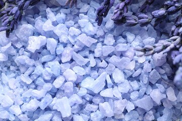 Natural sea salt and lavender flowers as background, closeup