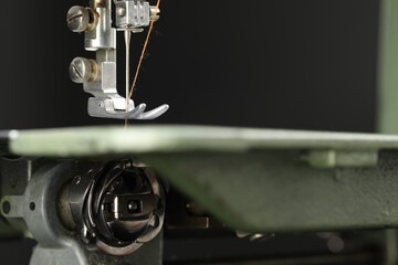 Professional sewing machine on blurred background, macro view