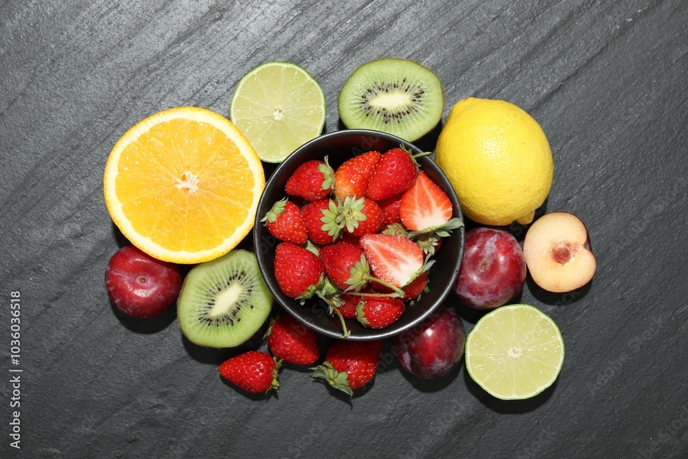 Wall mural Different fresh fruits on grey textured table, flat lay