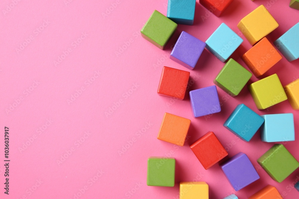 Sticker Many wooden colorful cubes on pink background, top view. Space for text