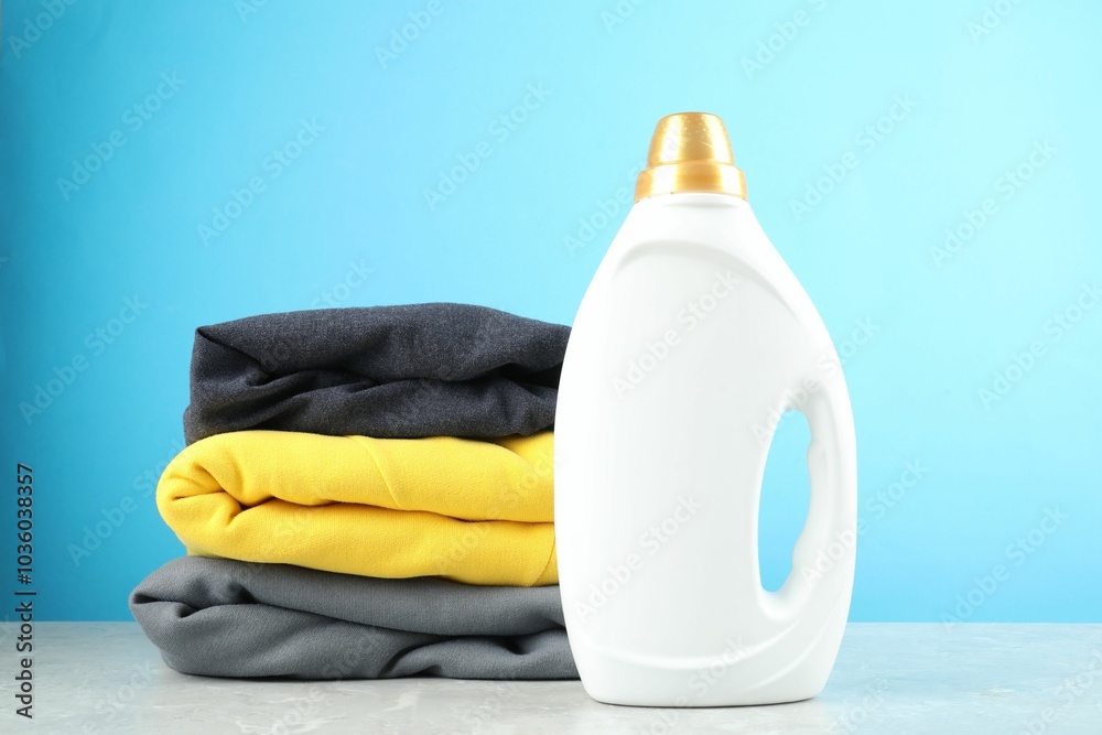 Canvas Prints Laundry detergent in bottle and clothes on grey marble table against light blue background