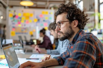 Software Engineer in Open Office Environment Collaborating with Team on Innovative Project