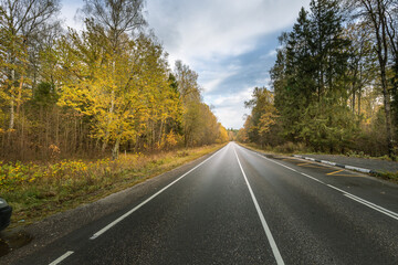 A road with trees in the background and a clear blue sky