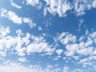 A picturesque view of a clear blue sky filled with fluffy white clouds, perfect for backgrounds or nature-themed projects.