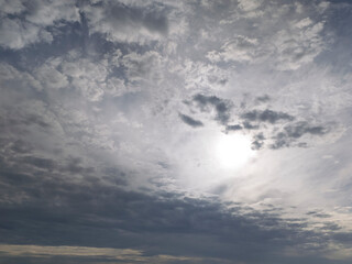 A dramatic sky filled with clouds and sunlight peeking through, creating a mesmerizing natural scene. Perfect for backgrounds or illustrating soothing atmospheres.