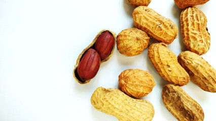 Peanut on the dried pod and dried pods on the white background 

