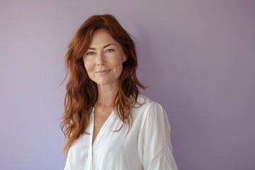 Obraz premium Confident Woman with Auburn Hair in White Blouse Against Soft Lavender Background