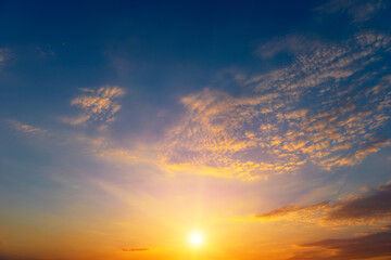 Beautiful sunset with bright sun and blue sky.