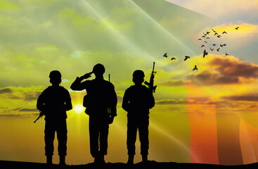Silhouettes of soldiers with a background of the Zambia flag and a sunset or sunrise. Concept of...