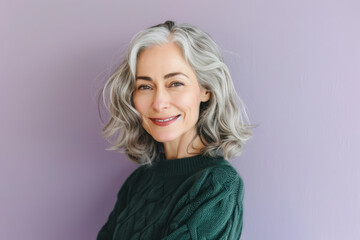 Fototapeta premium Elegant Woman with Grey Hair in Green Sweater Against Lavender Background for Portrait & Design