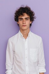 Obraz premium Calm and Inviting Portrait of Young Man in White Shirt with Lavender Background