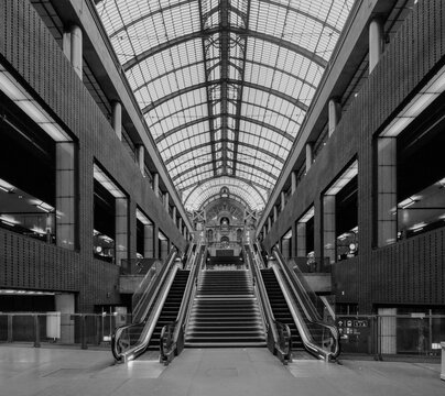 Black and white of Antwerp Central Station interior with escalators and arched glass roof