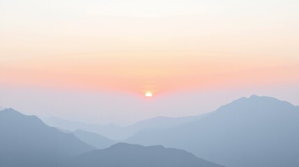 Obraz premium Sunrise over serene mountain ranges with misty valleys in the early morning light captured in a tranquil landscape