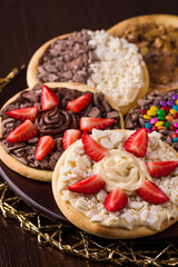 Assorted Gourmet Dessert Pizzas with Strawberries and Chocolate Toppings