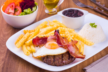 Delicious Bacon Egg Meal with Fries and Salad on Wooden Table