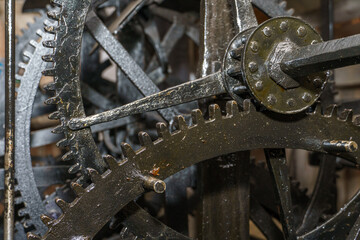 Church clockwork. The gear mechanism of a large old tower clock. Antique large clock mechanism with gears and cogs after restoration